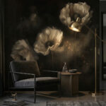 Tapeta czarna z białymi kwiatami. Nowoczesne, ciemne wnętrze salonu w formacie pionowym. Dominującym elementem jest fototapeta na czarnym tle przedstawiająca trzy duże, artystycznie rozmyte kwiaty w odcieniach złamanej bieli i szarości. Po lewej stronie stoi niski, minimalistyczny fotel z ciemnoszarą tapicerką na czarnym, metalowym stelażu. Obok fotela znajduje się okrągły, drewniany stolik z szklaną karafką. Po prawej stronie kompozycję domyka smukła, złota lampa podłogowa, której światło ciepło oświetla fragment tapety i podłogę. Na dole widoczny jest fragment teksturalnego, szarego dywanu.